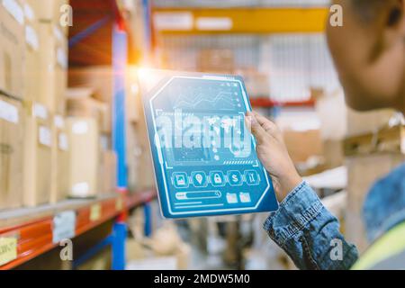 Inventory staff hand holding infographic Tablet for Advanced Digital Technology Warehouse Management concept. Stock Photo