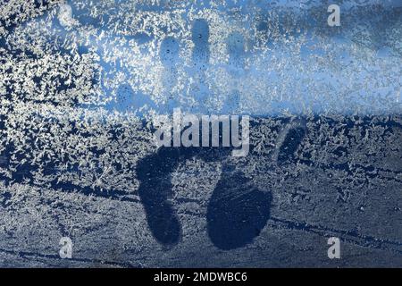 Handprint on an icy window, abstract background photo texture Stock Photo