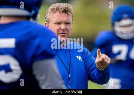 Kentucky offensive line coach Eric Wolford runs a drill during a