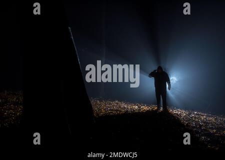 Suicide armed silhoulette man in dark forest at backlight Stock Photo