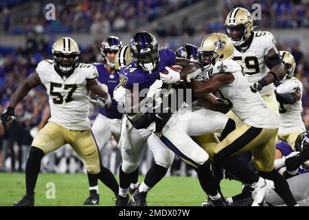 Baltimore Ravens running back Ty'Son Williams (34) pushes through the goal  line to score a two-point conversion against the New Orleans Saints during  the second half of an NFL preseason football game