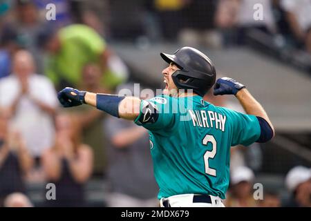 Seattle Mariners' Tom Murphy reacts in the dugout after he hit a