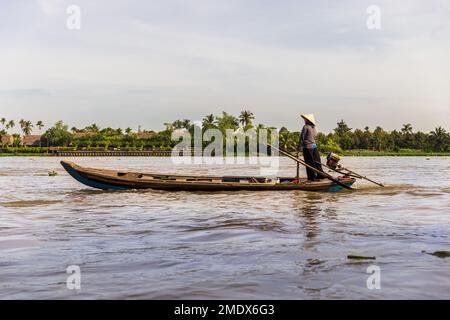 CAN THO, VIETNAM - JANUARY 2, 2023 : A Vietnamese women on a motor boat on the Mekong River Stock Photo