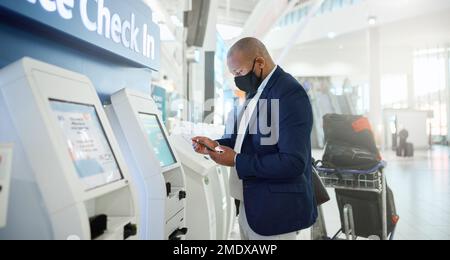 Black man, mask and checking phone in airport for corporate travel information, destination details and flight ticket. African businessman, digital Stock Photo