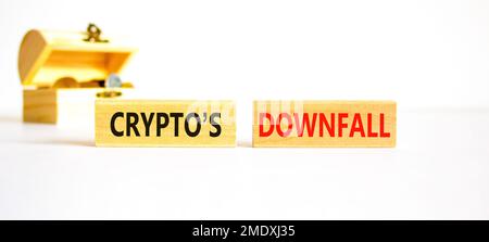 Crypto downfall symbol. Concept words Cryptos downfall on wooden blocks. Beautiful white table white background. Wooden chest with coins. Business and Stock Photo