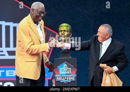 Harold Carmichael, left, a member of the Pro Football Hall of Fame  Centennial Class reacts after unveiling his bust beside his presenter James  Solano during the induction ceremony at the Pro Football