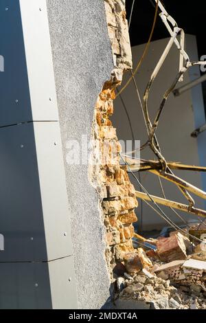 Demolition of the old building with sloopkraan against blue clouds sky. Stock Photo