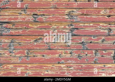 A portion of wall of weathered painted boards on the exterior of a building in a historic Colorado town. Stock Photo