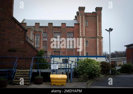 An exterior view of buildings within the precincts of HMP Liverpool, also known as Walton Prison. The prison was given a scathing report in 2017 which pointed out various failings and problems. Present governor Pia Sinha was appointed in that year and in the next two years she turned the prison around with a programme of improvements and support for inmates and infrastructure. HMP Liverpool houses a maximum of 700 prisoners with an overall staff of around 250. Stock Photo