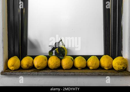 Lemons lined up in a row on a window sill in Capri, Italy. Stock Photo