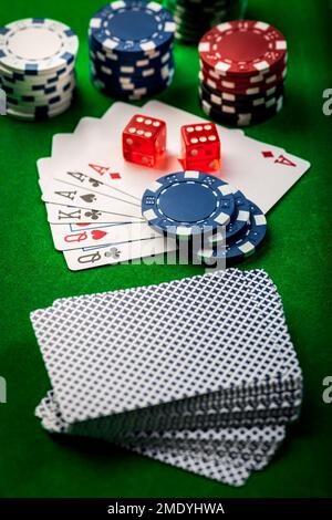 Playing cards, dice and poker chips , casino poker chips on green background Stock Photo
