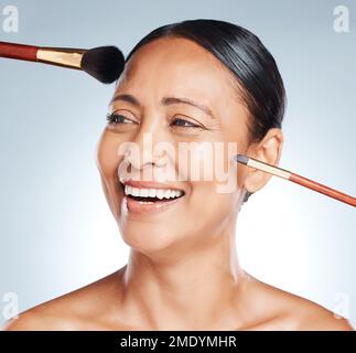 Makeup, brushes and woman in a studio with a cosmetic, beauty and natural facial routine. Happy, smile and headshot of a mature female with face or Stock Photo