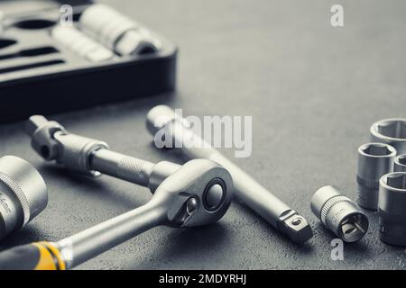 Ratchet and bits tool kit. Socket wrench and ratchet heads. Tool kit for the car on background. Equipment for auto mechanic for car repair at service Stock Photo