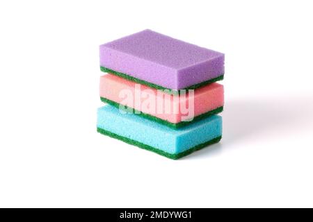 A stack of colored kitchen sponges isolated against white background. Multi-colored Dish washing sponges. Stock Photo