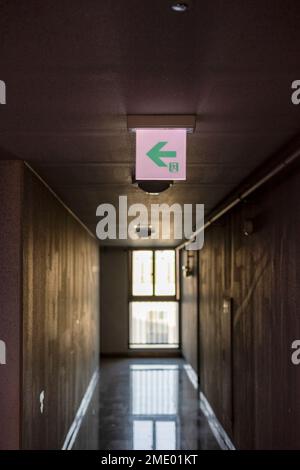 Emergency exit sign at the hallway of building Stock Photo