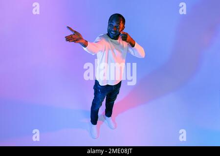 Handsome african american man showing free space, high angle view Stock Photo