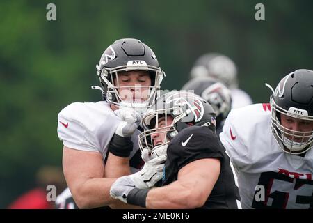 Atlanta Falcons guard Ryan Neuzil (64) works during the first half of an  NFL football game