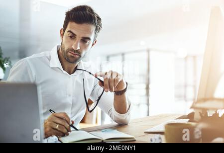 Leave no room for error. a young businessman working in an office. Stock Photo