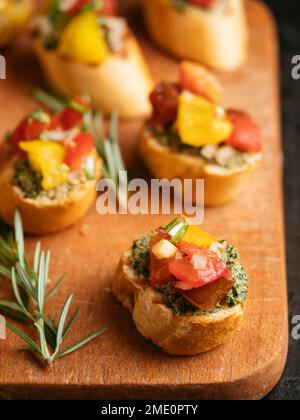 Bruschetta with carrot green pesto and shopped tomatoes. Stock Photo