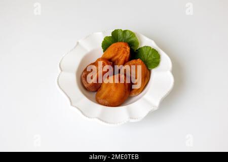 White plate of Dried Persimmon on the white background Stock Photo