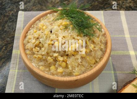 Cabbage with peas served in wooden bowl. Traditional Polish  Christmas Eve  dish. Stock Photo