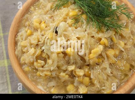 Cabbage with peas served in wooden bowl. Traditional Polish  Christmas Eve  dish. Stock Photo