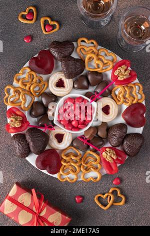 Plate of assorted heart sweets for Valentine's Day, top view, vertical image Stock Photo