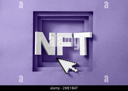 NFT text in a purple frame and a mouse pointer cursor. Minimal concept of virtual innovations and digital art and payments. High quality photo Stock Photo