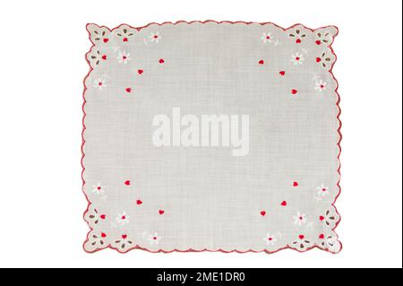 See isolated red hearts hanky handkerchief  with eyelet  scalloped border. Round text space is centered. Fine fabric is vintage or retro and square. Stock Photo