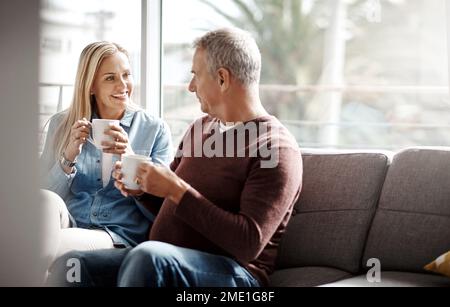 Sunday afternoons were made for quality time. a mature couple enjoying a relaxing coffee break on the sofa together at home. Stock Photo