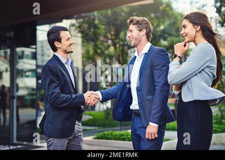 Meeting all different types of entrepreneurs. businesspeople meeting and greet outside. Stock Photo