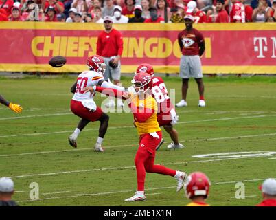 American football in foreground with logo of NFL team Kansas City