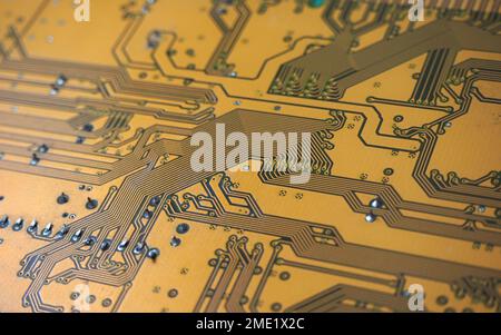 Printed circuit board (PCB). Lines on the electronic card. Digital electronic boards in gold color. Stock Photo