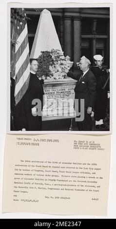 Reverend Alexander Hamilton and the Honorable John F. Shelley Placing a Wreath at the Grave of Alexander Hamilton in Trinity Churchyard. The 200th anniversary of the birth of Alexander Hamilton and the 167th anniversary of the Coast Guard he founded were observed in New York City August 4th by members of Congress, Coast Guard, Coast Guard League officials, and numerous members of various civic groups. Pictured above placing a wreath at the grave of Alexander Hamilton in Trinity Churchyard are the Reverend Alexander Hamilton (left) of Norwalk, Conn., a great-great-grandson of the statesman, and Stock Photo