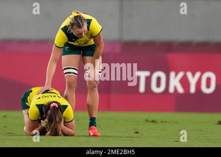 Australia's Maddison Levi, right, comforts teammate Charlotte Caslick