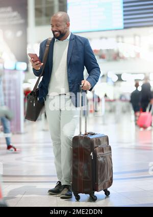 Phone, travel or happy black man in airport typing, chatting or networking via email online. Airplane, smile or excited African businessman reading Stock Photo