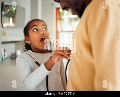 Surprise, stethoscope and girl play with father, caring and bonding in home. Black family, wow and shocked kid holding medical toy, listening to Stock Photo