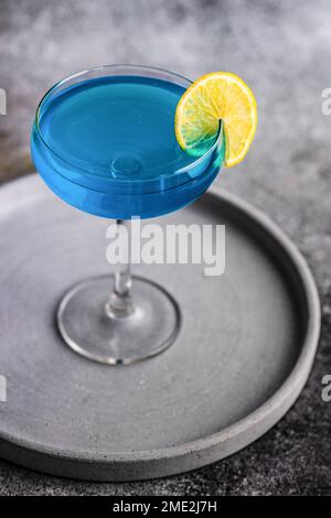Cocktail high glass with blue kamikaze drink decorated with fresh mint ...