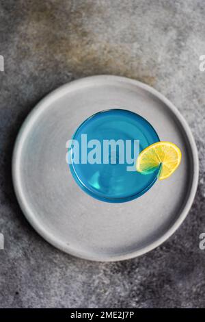 Cocktail high glass with blue kamikaze drink decorated with fresh mint ...