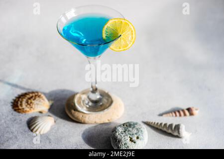 Glass of blue kamikaze drink on stone in modern style Stock Photo