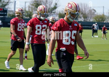 San Francisco 49ers tight ends Vance McDonald (89) and Garrett Celek (88)  take a knee following guard, Mike Iupati's (77) game ending injury during  the NFC Championship Game against the Seattle Seahawks