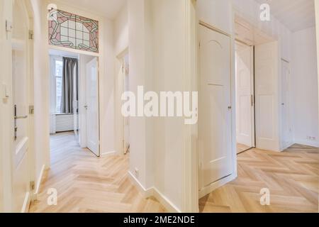 Interior of spacious light apartment with parquet floor and white walls without furnish Stock Photo