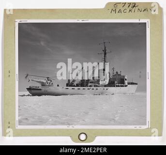 'Big Mac' USCG Icebreaker Mackinaw (WAGB 83). This image depicts the 'Big Mac' as sometimes the U. S. Coast Guard icebreaker Mackinaw is called, is shown here beginning early March icebreaking operations in the Straits of Mackinac, heralding the spring opening of Great Lakes shipping. An HO4S-2G helicopter (from Coast Guard Air Station, Traverse City, Michigan) perched on the stern makes ice surveys for the icebreaker during its 6 to 8 weeks of icebreaking operations. Stock Photo