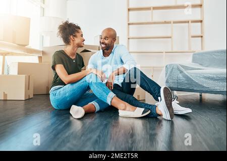 We should start planning our housewarming soon. a young couple taking a break while moving house. Stock Photo