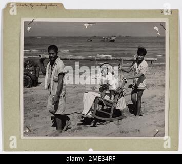 To the Doctor By Rocking Chair. To the Doctor By Rocking Chair. Along the Lingayen Gulf beach, a wounded Filipino boy is carried to an American medical station in a rocking chair by his father and brother. He became a casualty during the sharp fighting that marked the amphibious landings of Yankee troops from Coast Guard-manned landing barges on Luzon, Jan. 9. Stock Photo