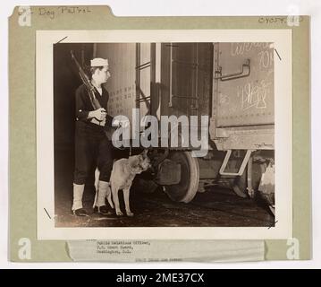 Coast Guard Dog Patrol. This image depicts a Cost Guardsmen assigned to patrol railroad sidings which are loaded with war materials. Stock Photo