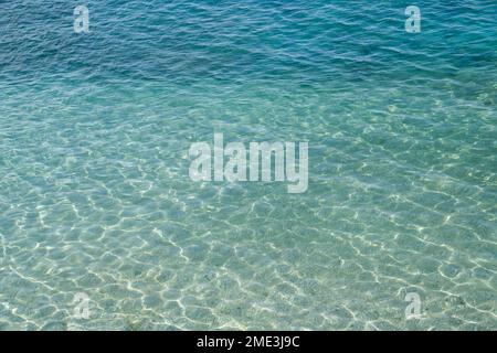 Seawater surface, sun's rays shimmer on water surface, top view Stock Photo