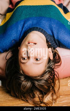 Girl lying on a bean bag and using a laptop Stock Photo - Alamy