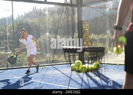 Young woman playing paddle tennis at sports court Stock Photo
