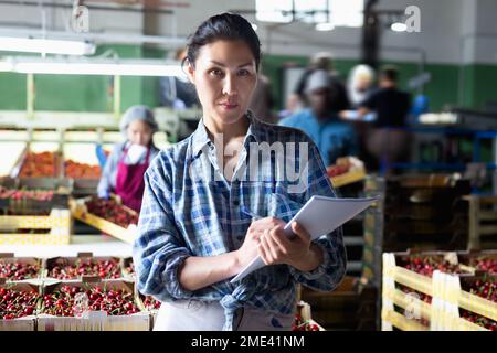 Woman is working in a warehouse Stock Photo